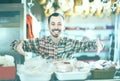 Smiling man butcher showing sorts of meat